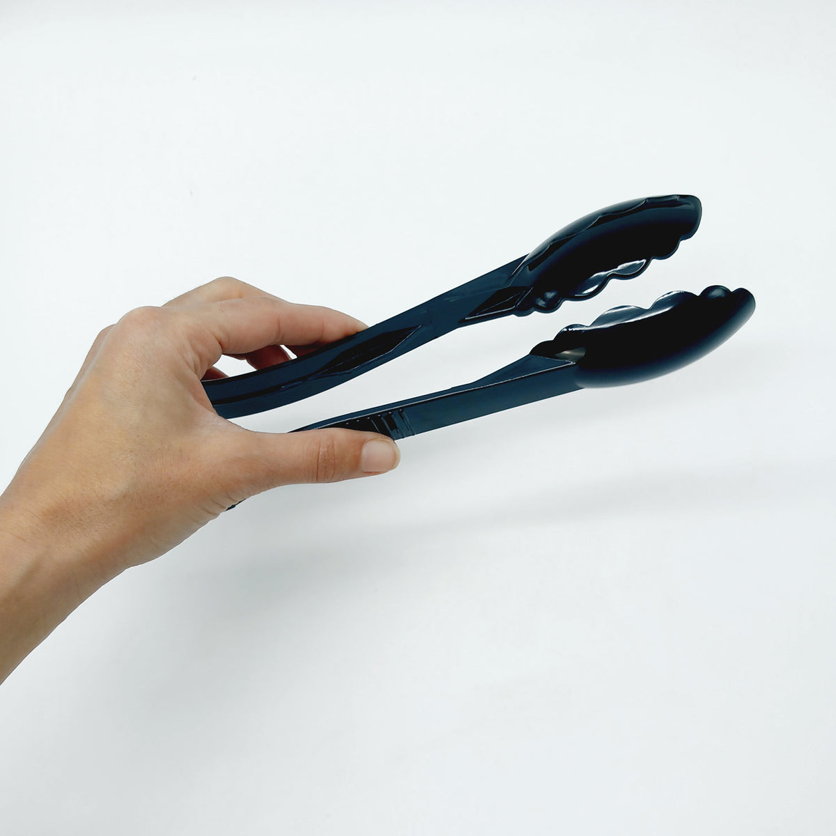Pinza per cucina nera retta da una mano