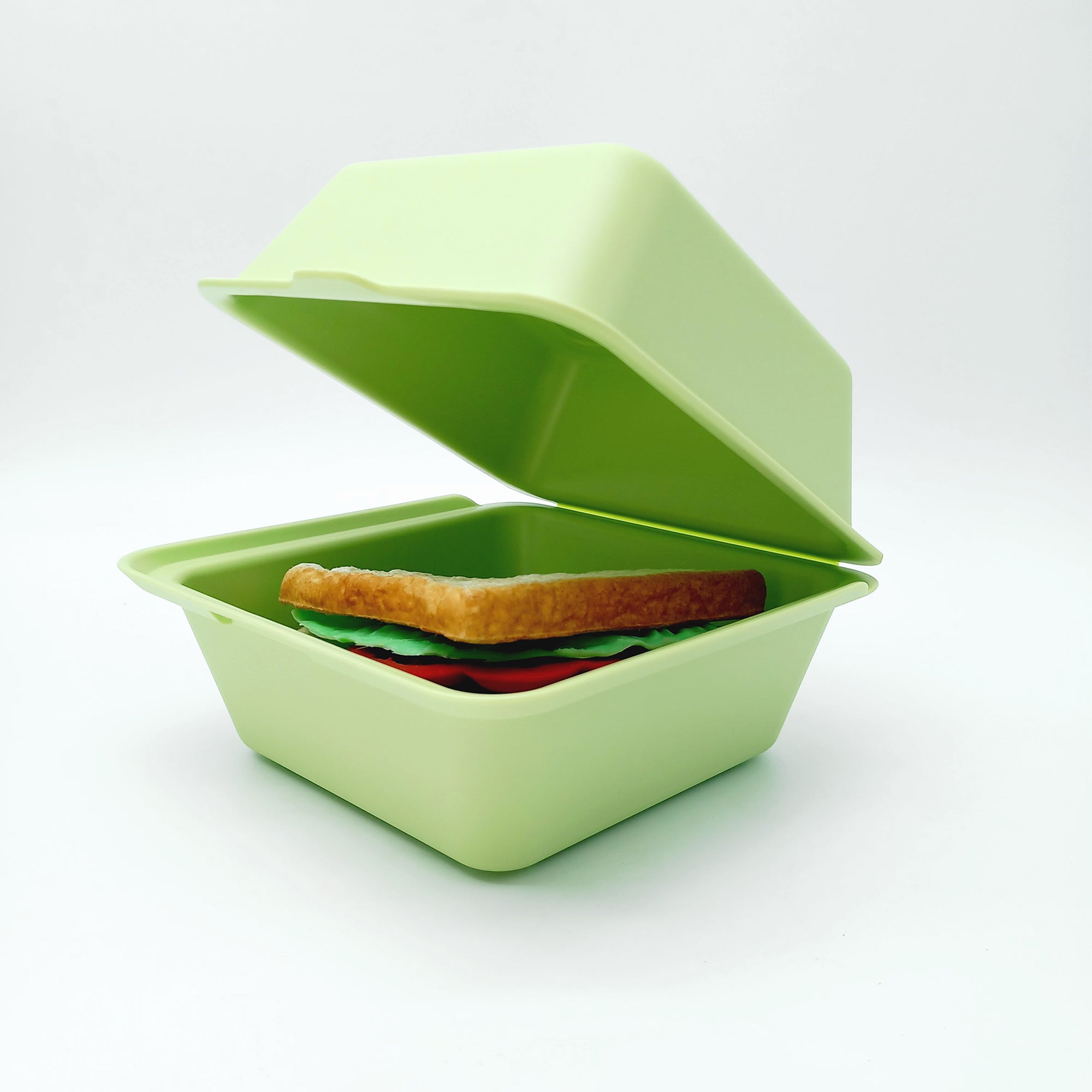 Porta merenda verde chiuso visto aperto con dentro sanwich