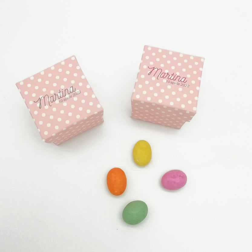 Scatole bomboniere, rosa a pois bianchi, viste dall'alto, personalizzate con i nomi Martina. 4 confetti colorati adagiati vicino