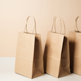 Serie di shopper in carta color avana 