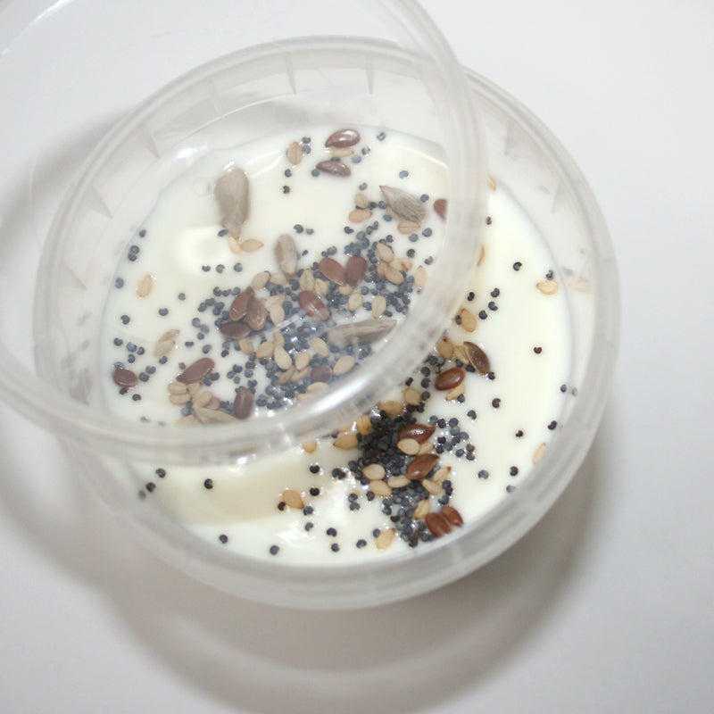 Vasetto di plastica con coperchio pieno di yogurt 