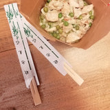 Bacchette cinesi vicino a riso alla cantonese dentro confezione di carta da asporto 