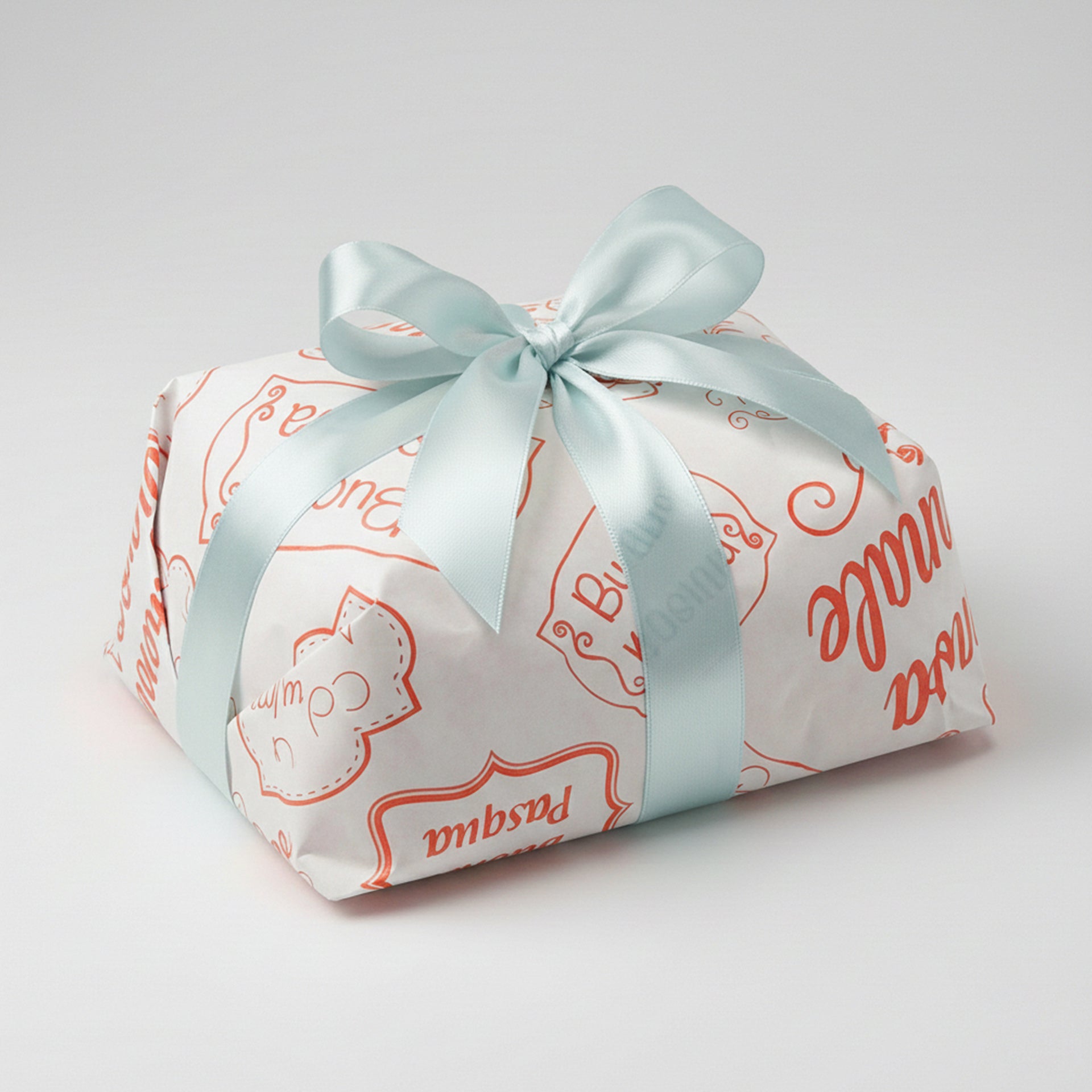 Carta colomba bianca con scritte color arancione di buona Pasqua attorno ad una colomba e nastro azzurro