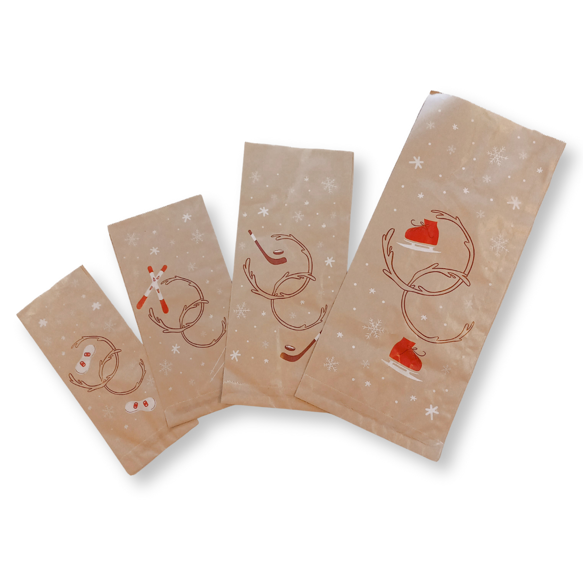 Tre sacchetti di carta color avana con simboli natalizi 