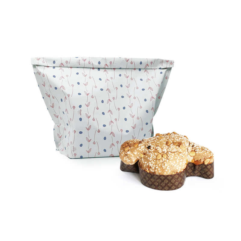 Sacchetto porta colomba pois lilla e foglioline rosa, vicino ad una colomba pasquale 