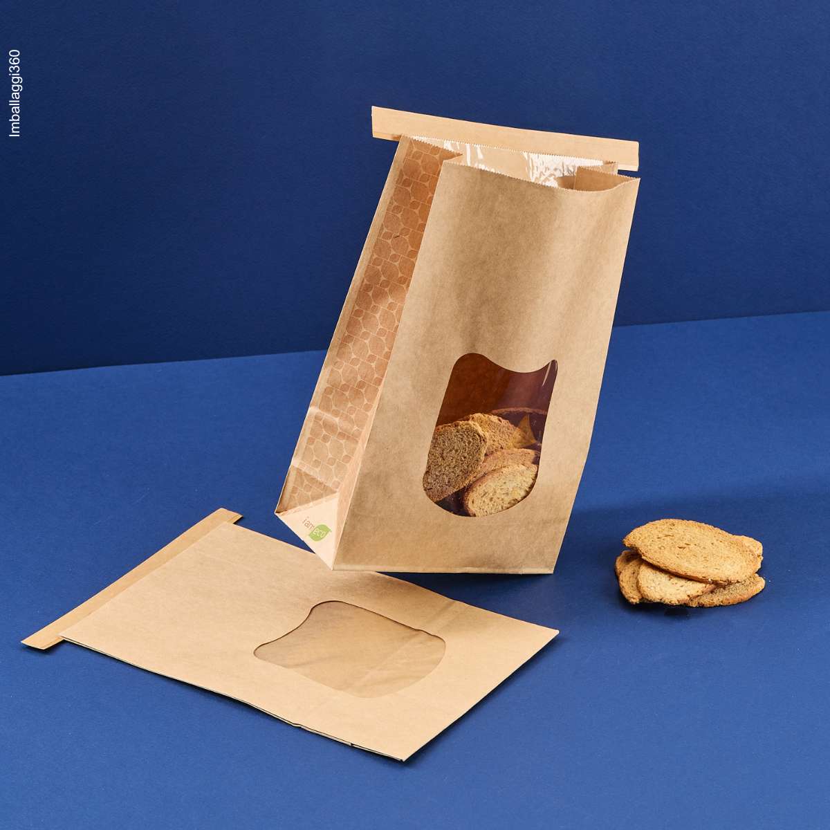 Sacchetto porta alimenti avana con finestra mostrato ripieno di pane e steso chiuso