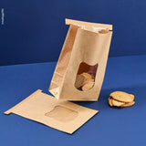 Sacchetto porta alimenti avana con finestra mostrato ripieno di pane e steso chiuso