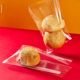 Sacchetto microforato , mostrato con del pane, dentro, anche steso. Sfondo rosso