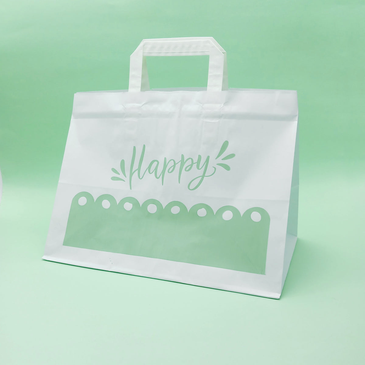 Shopper bianca, a fondo largo, con grafica verde happy, su sfondo verde