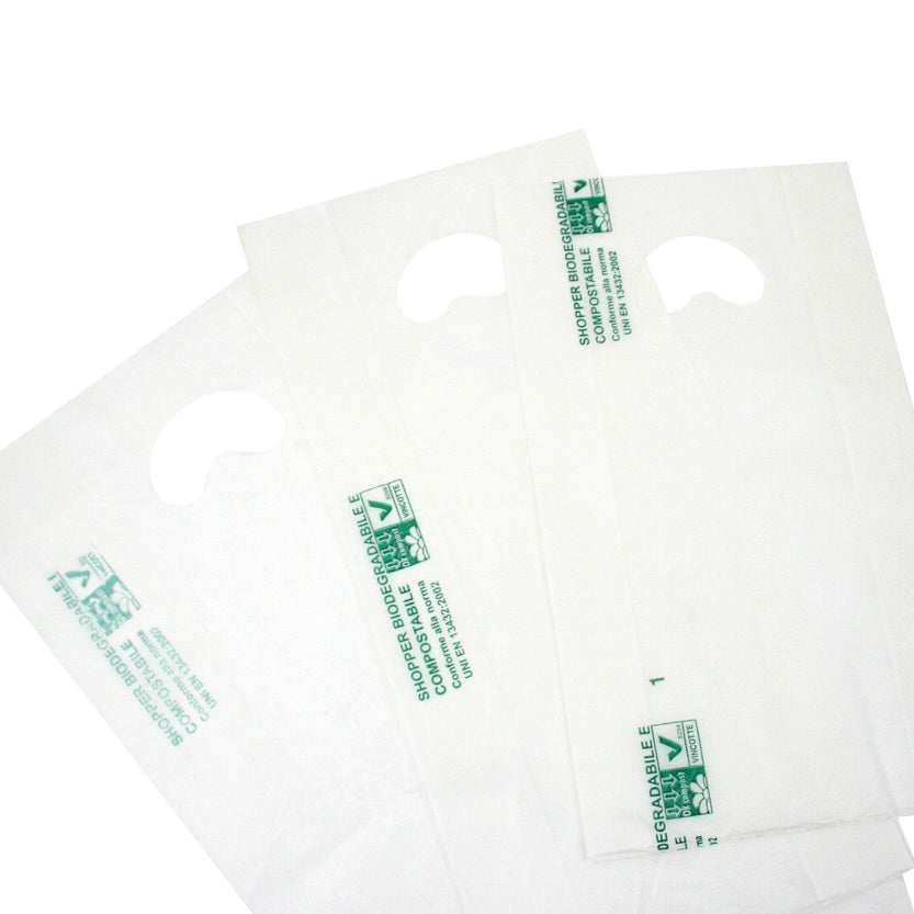 Tre shopper biodegradabili bianche di tre diverse misure, stese 