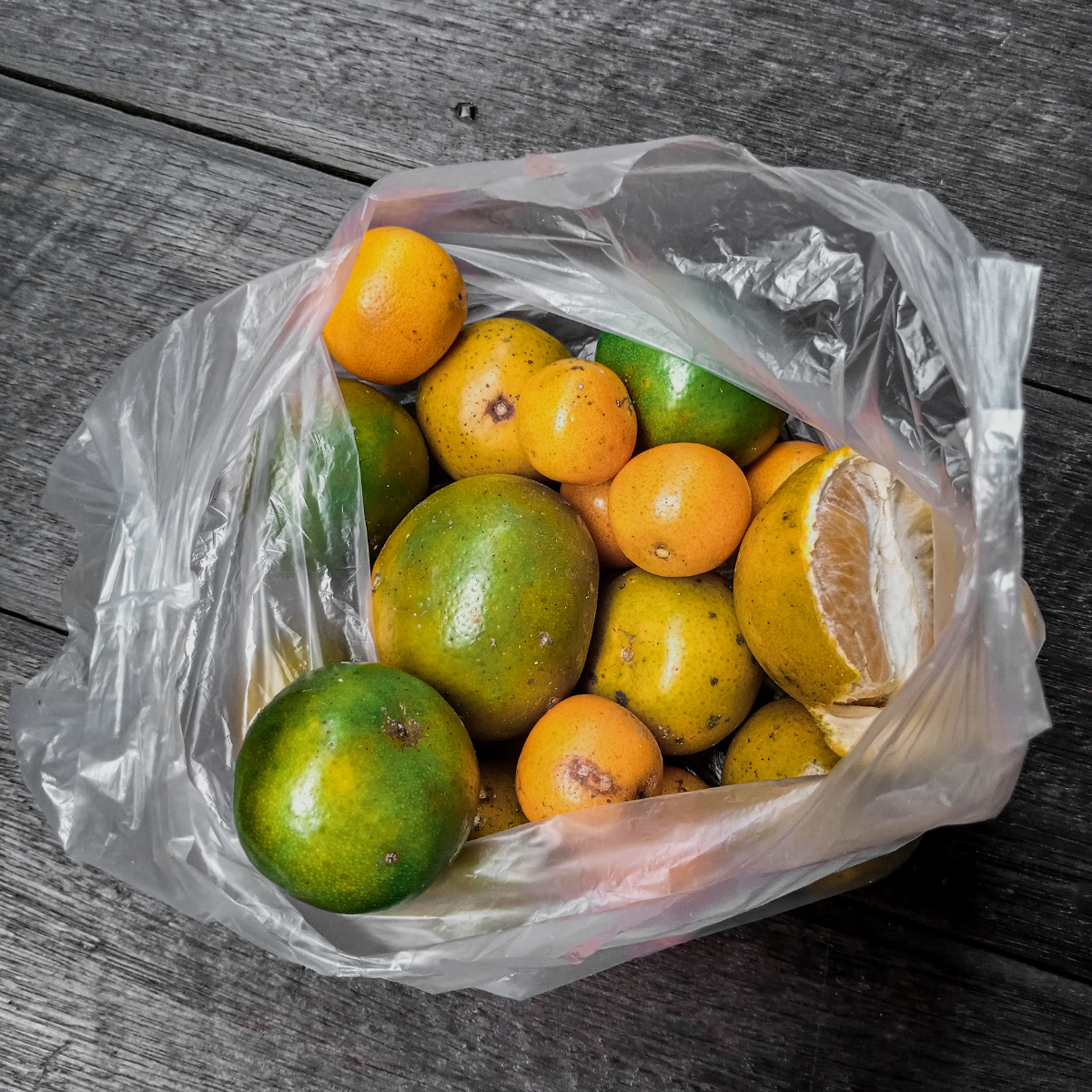 Shopper per frutta, piena di agrumi, aperta, su un tavolo