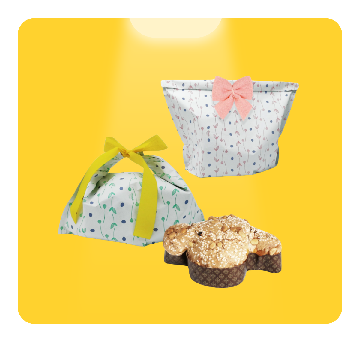 Colomba di pasqua, mostrata senza incarto e con due carte con grafiche, su sfondo giallo 