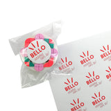 Adesivo tondo bianco BELLO essere con te , su una cnfoezione e nel suo foglio