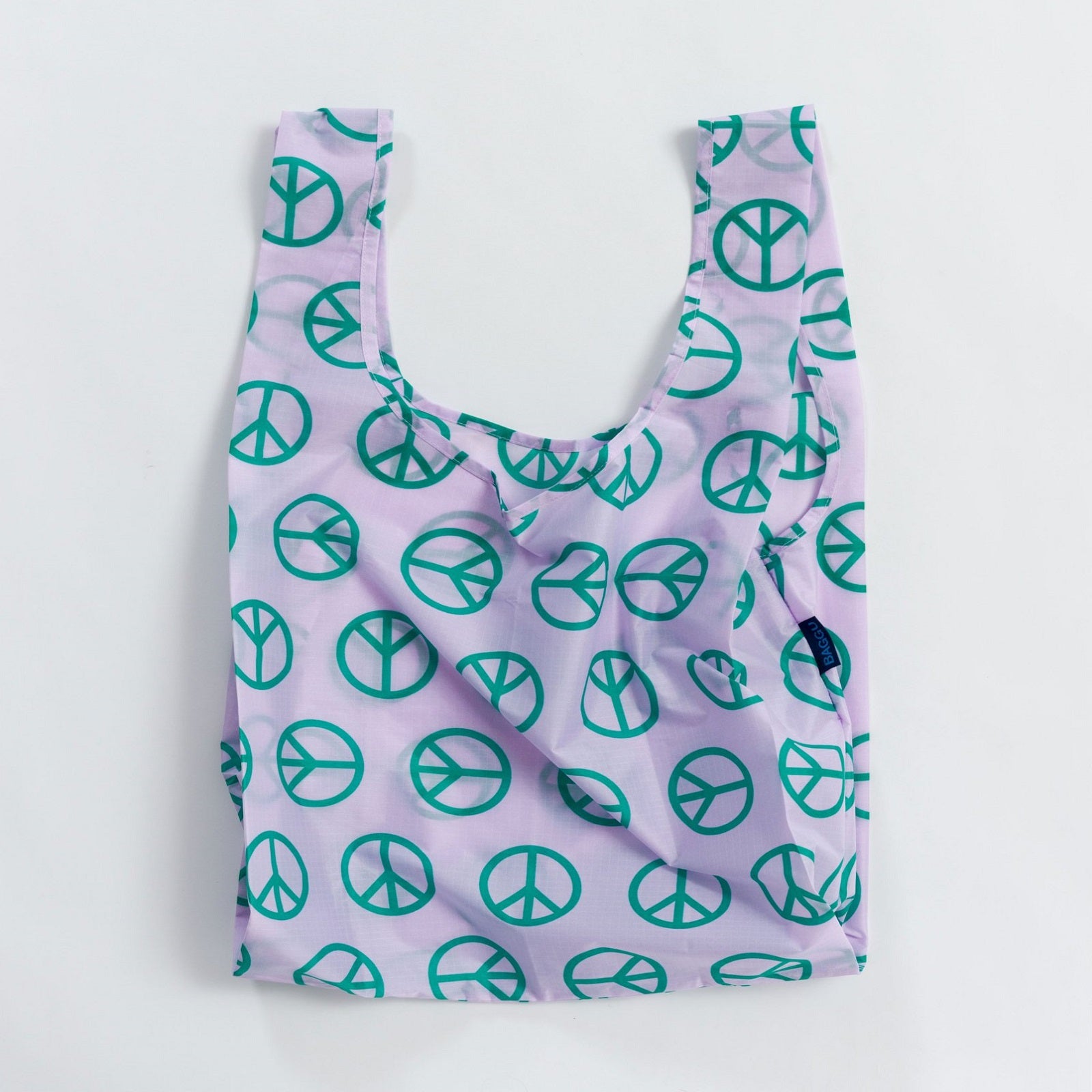 Shopper riutilizzabile lilla con simboli della pace verdi