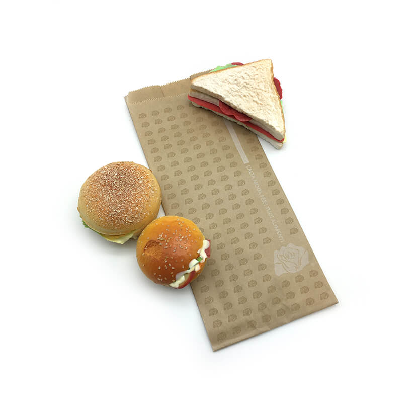 Sacchetti di carta antigrasso colore avana, e tre panini. steso 