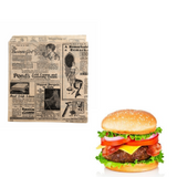Sacchetto di carta alimentare color avana con fantasia giornale retro steso e con un hamburger vicino 