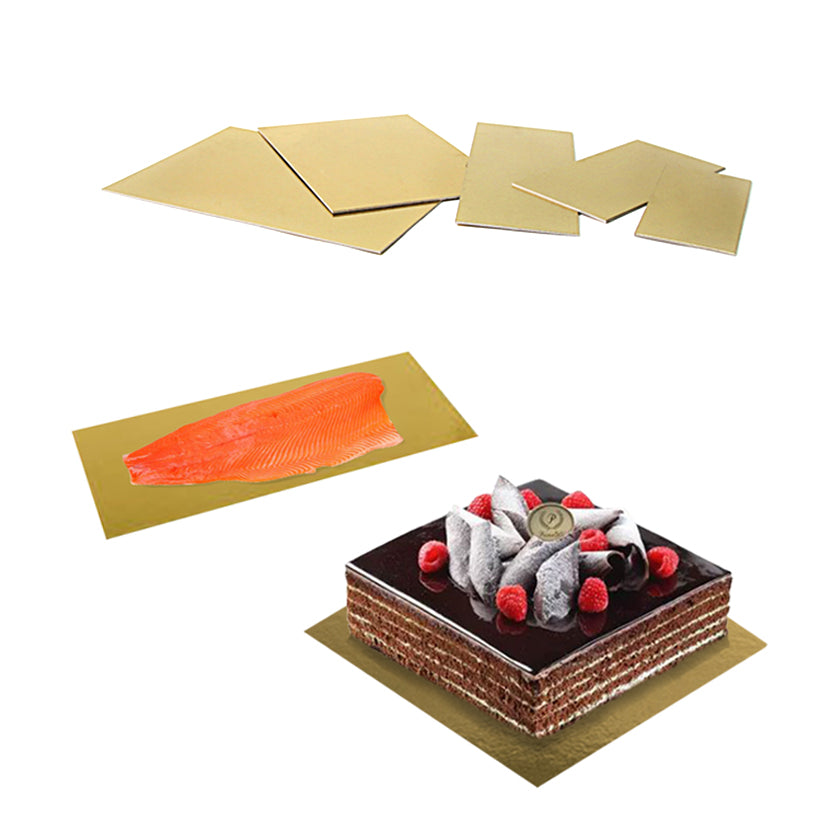 Sottotorta oro in cartone, diverse misure e vuoti, uno quadrato con sopra una torta ed uno rettangolare con sopra salmone