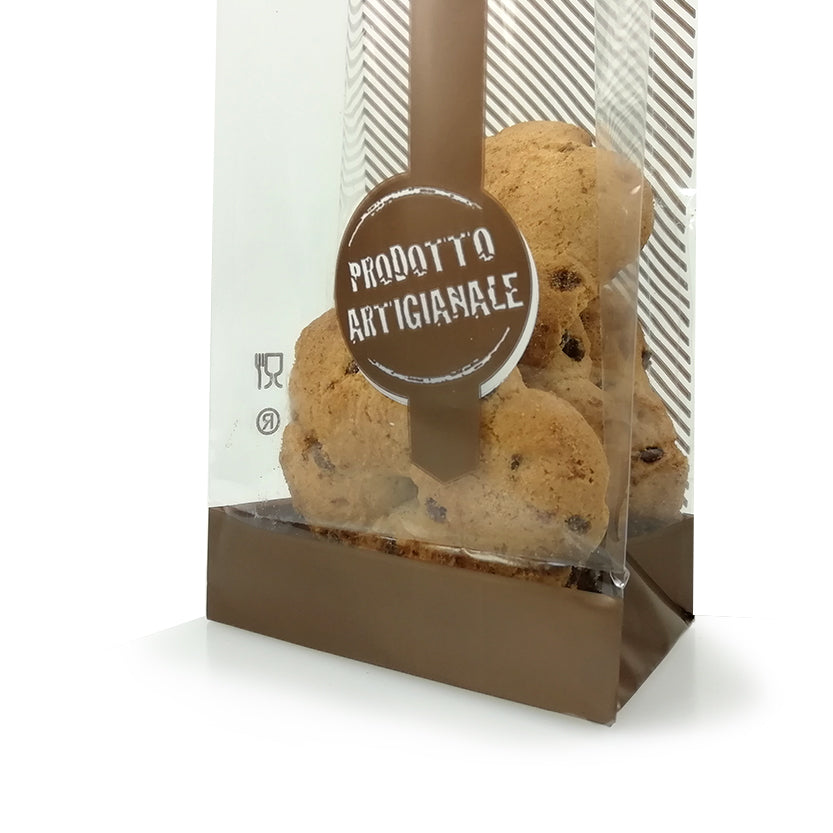 Dettaglio di sacchetto trasparente con prodotto artigianale scritto, pieno di biscotti 