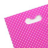 Dettaglio manico busta di plastica rosa a pois bianchi