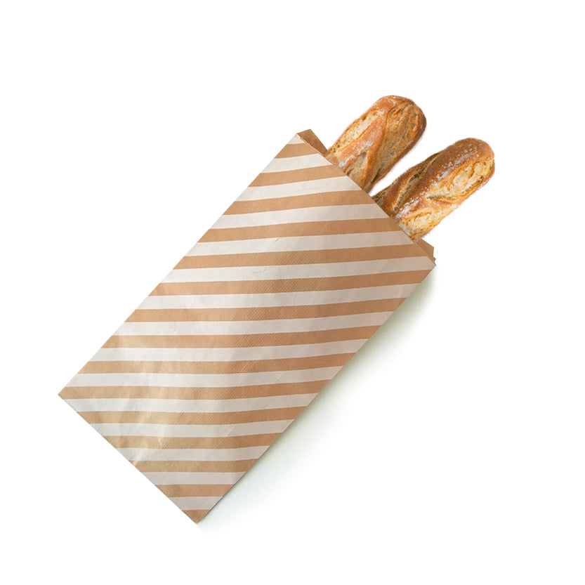 Sacchetto di carta a righe per il pane con dentro del pane 