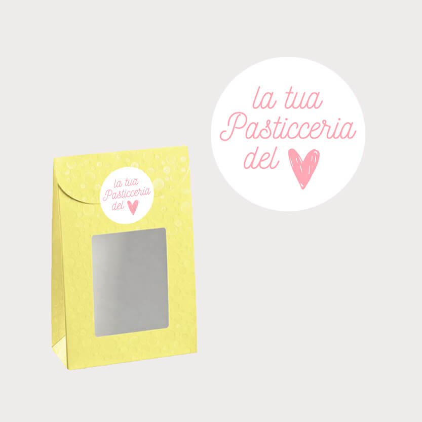 Etichetta bianca tonda la tua pasticceria del cuore mostrata singola e su una confezione verde con finestra 