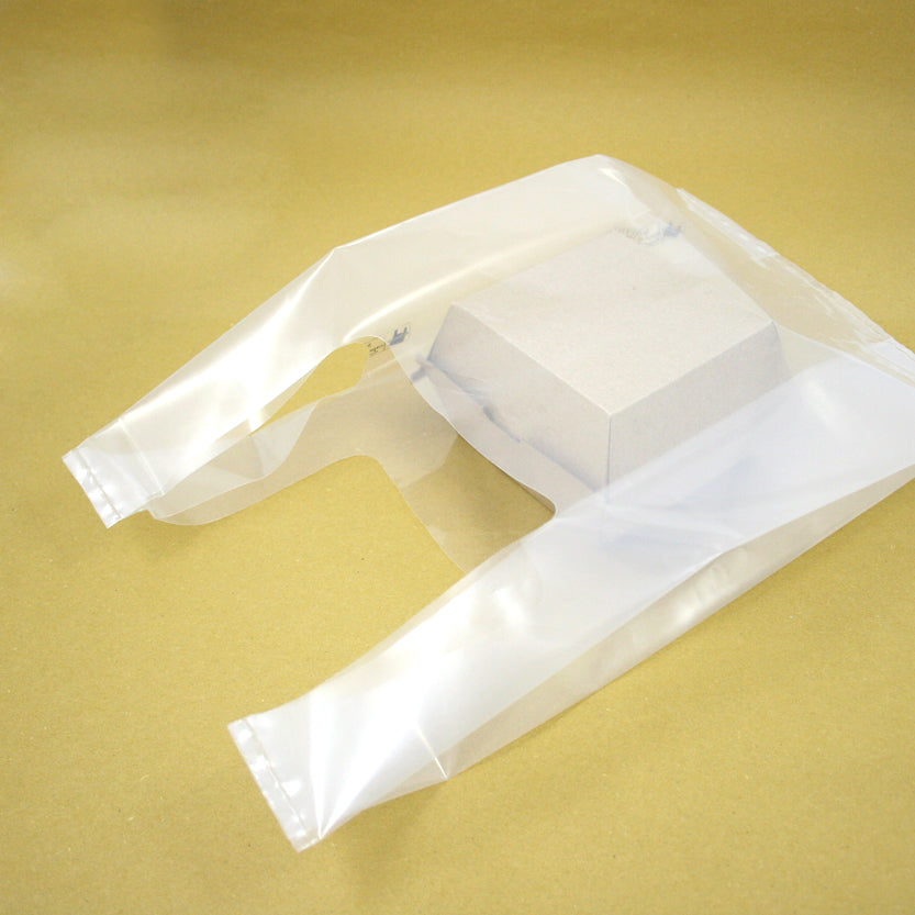 Shopper di plastica bianca con dentro scatola porta hamburger avana 